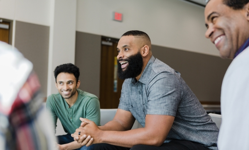 Men Laughing Together In Discussion