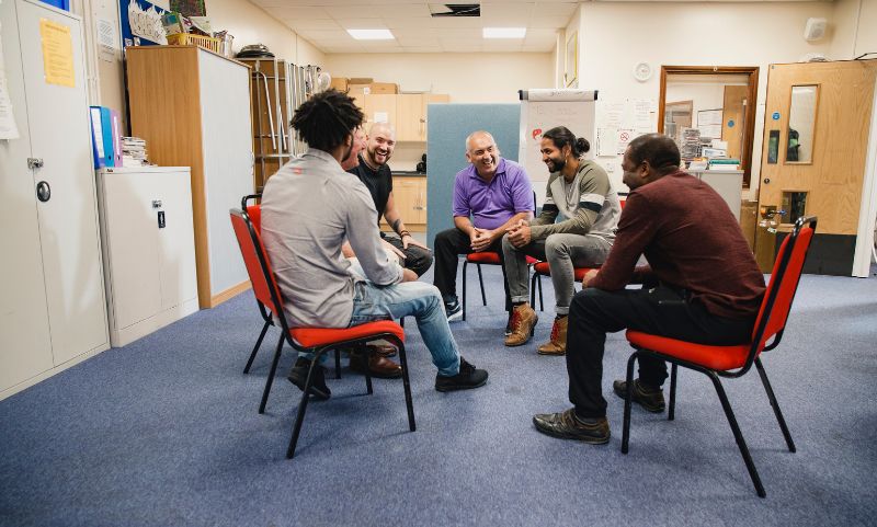 Group Of Men Sitting In A Circle