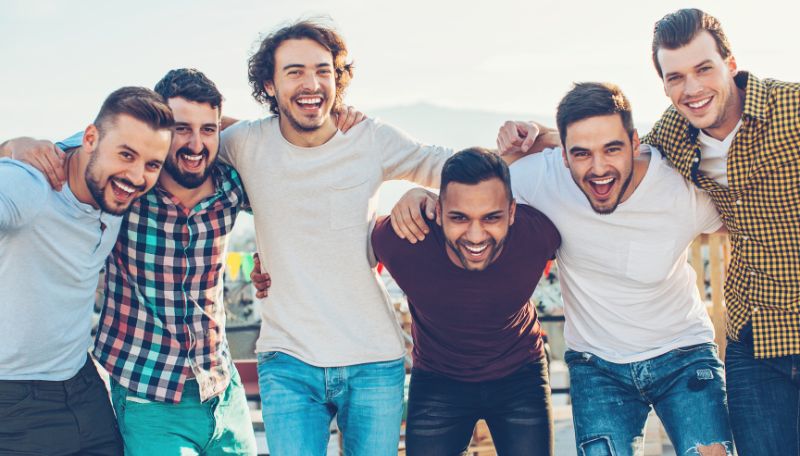 Group Of Smiling Men Standing Together