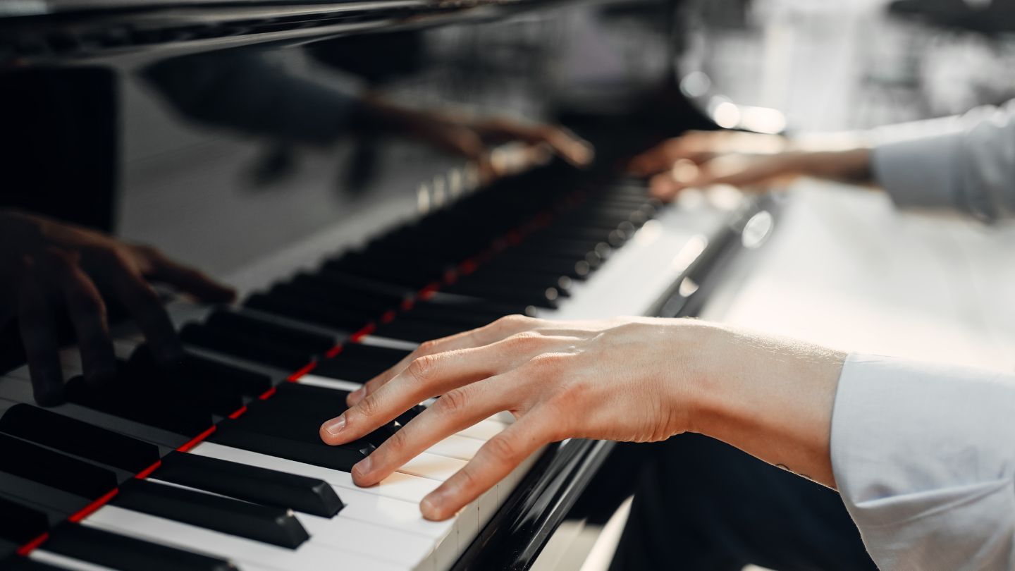 Person Playing Piano Keys